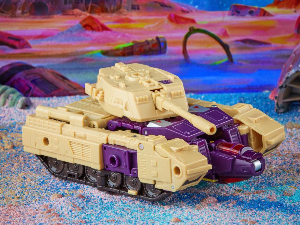 Toy tank with beige and purple design on a colorful sand-like surface